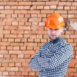 Bricklayer in protective clothing and hard hat